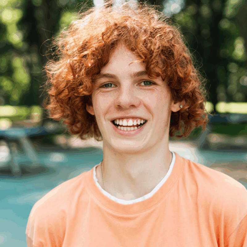 Smiling red-haired teen enjoying the outdoors, symbolizing the confidence, comfort, and personalized care delivered through the Palencia Promise